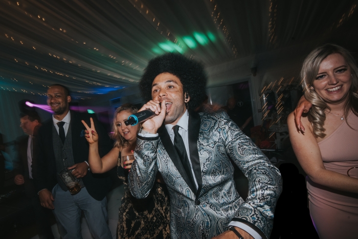 Lead singer dancing in crowd at wedding