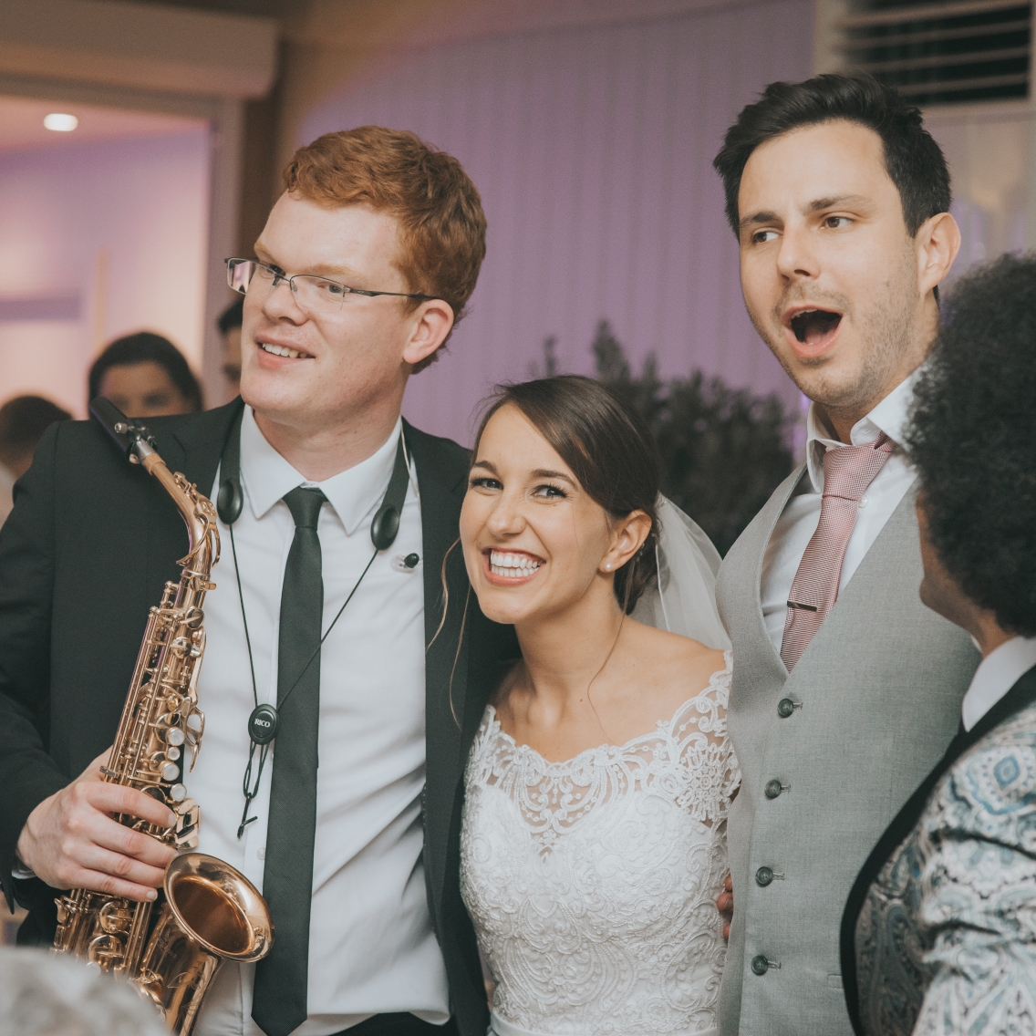 Bride and groom with saxophonist and lead singer